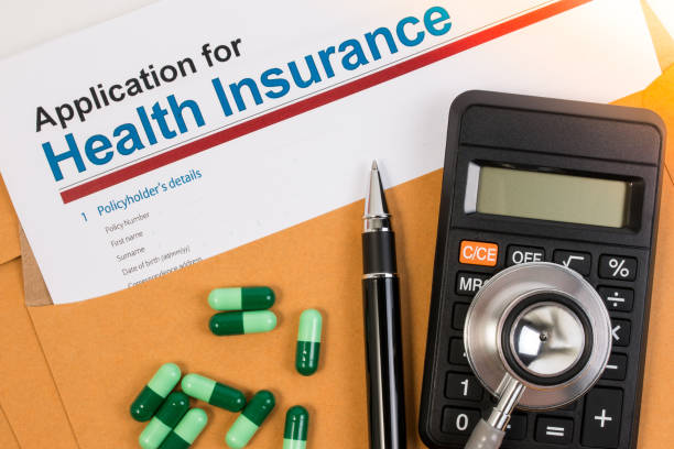 istock Application form for health insurance, paperwork, questionnaire, pen, tablet, calculator, envelope and stethoscope. 671870674