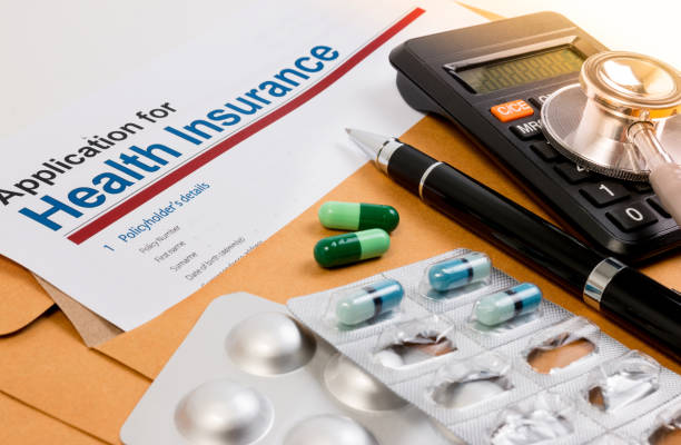 istock Application form for health insurance, paperwork, questionnaire, pen, tablet, calculator, envelope and stethoscope. 671870684