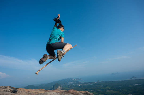istock jumping on rocky mountain peak, freedom, risk, challenge, success concept 671876528