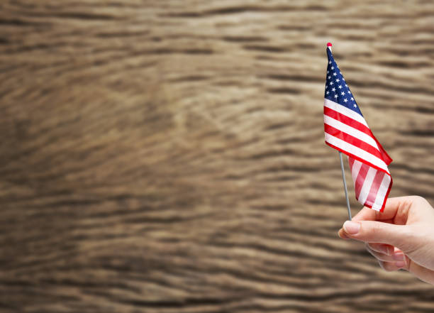 istock Hand holding USA flag 671876744