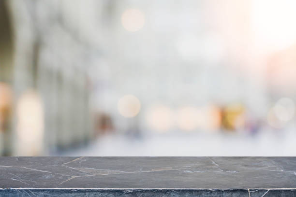 istock Stone table top and blurred shopping plaza background 671877276