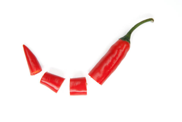 istock Red hot chilies with powder over white background 671882978