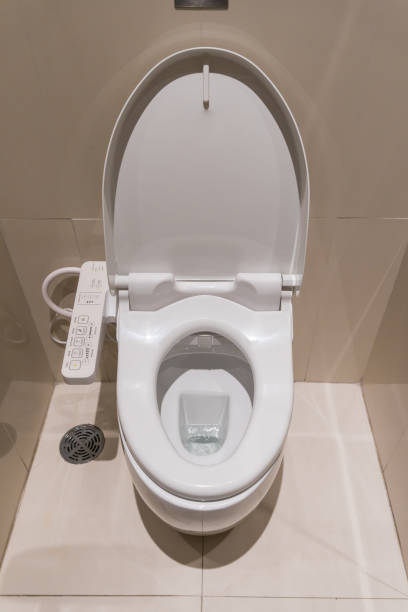 istock white flush toilet with electronic control in modern bathroom interior 671888820