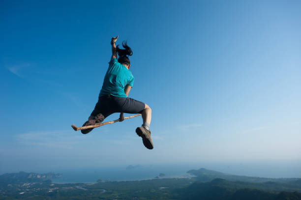 istock jumping on rocky mountain peak, freedom, risk, challenge, success concept 671889416
