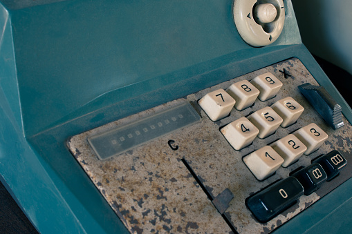 close up of the keyboard of an antique cash register, on retail display for sale at a junkyard, Long Island, New York