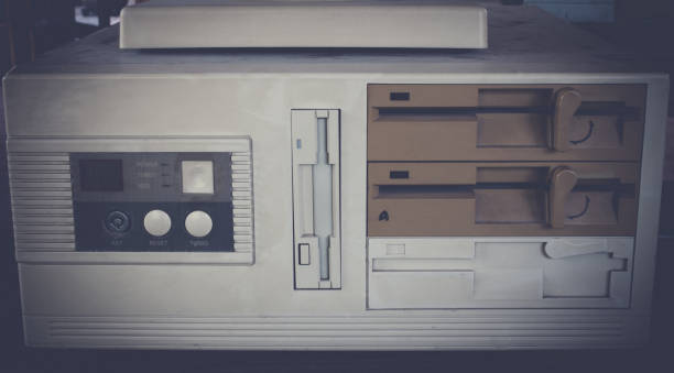 istock Close-up of ancient old and obsolete personal computer home use on old table wood. 671903244