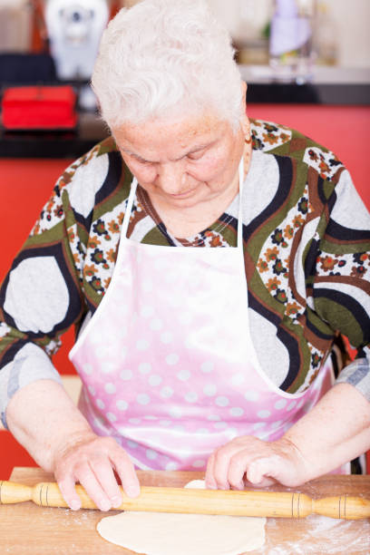istock Woman kneading dough on kitchen counter 671909056