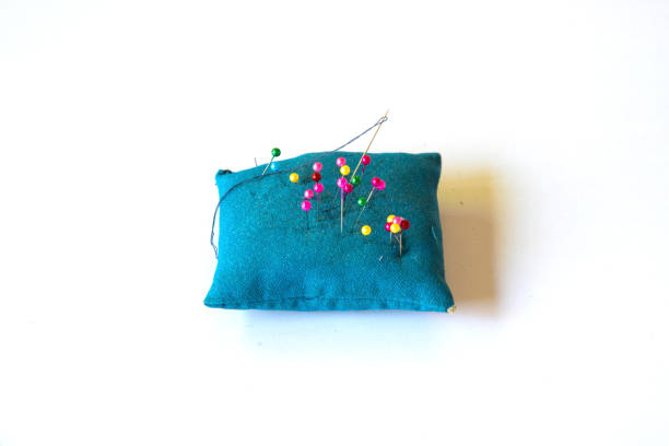 Colorful pins put on blue pillow for sewing
