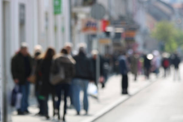 istock Blurred People walking in the street 671913038