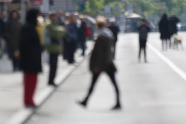 istock Blurred People walking in the street 671913066