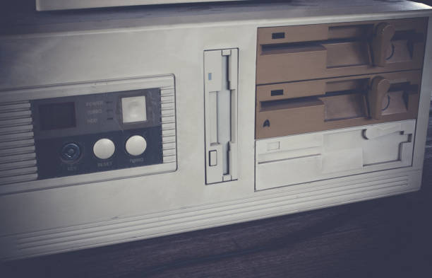istock Close-up of ancient old and obsolete personal computer home use on old table wood. 671915698