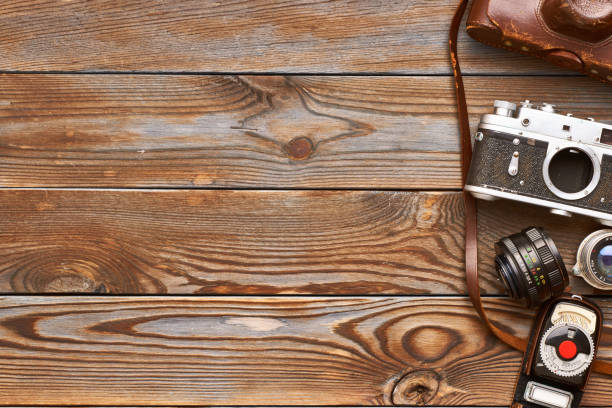 istock Vintage cameras and lenses on wooden background 671915848