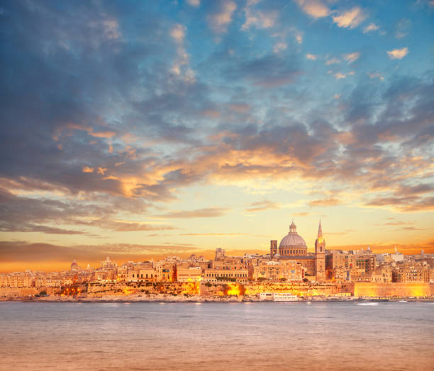Beautiful spires and cathedral dome of Valletta under dramatic sky on the sunset Beautiful spires and cathedral dome of Valletta under dramatic sky on the sunset. Valletta, capital of Malta. valletta photos stock pictures, royalty-free photos & images