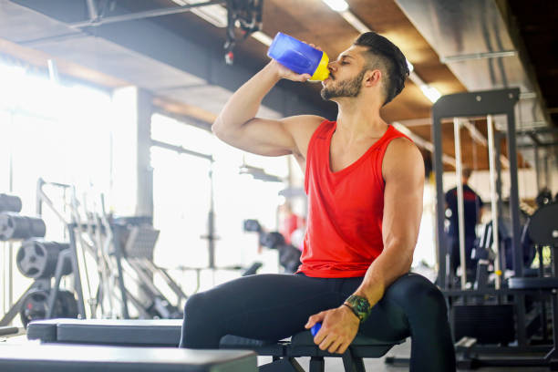 istock Young muscular man drinking a protein drink 671922668