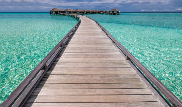 istock Beautiful beach with water bungalows 671923128