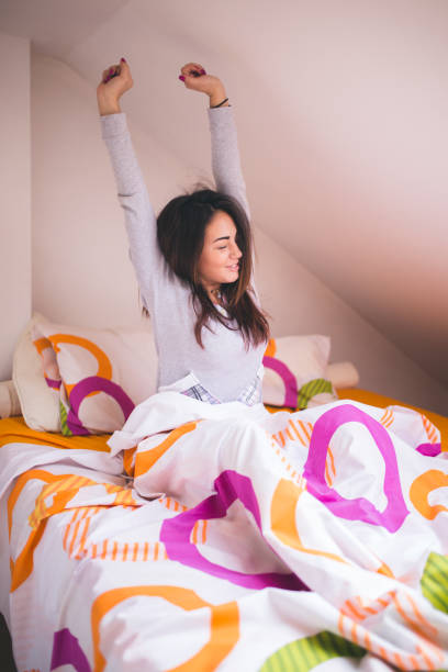 istock Woman stretching in bed after wake up 671930004