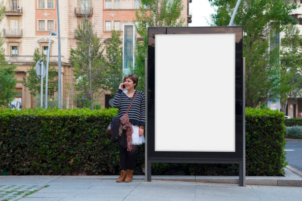 istock Blank billboard and woman with mobile 671935150