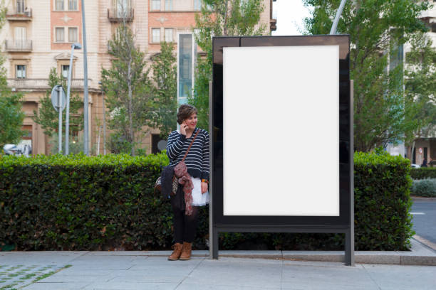 istock Blank billboard and woman with mobile 671935386