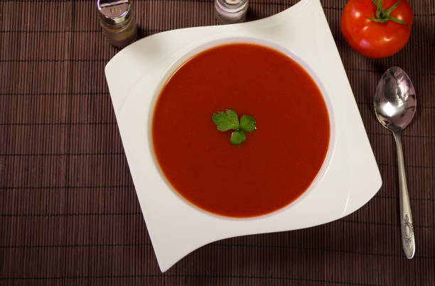 istock Soup tomato in white plate with parsley and tomatoes 671938564