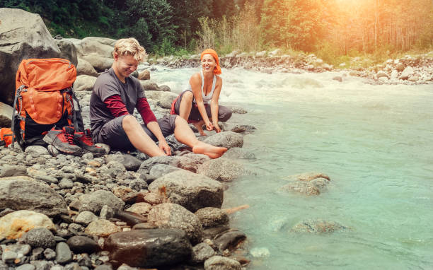 istock Two travelers refreshing on the mountain riverside 671942096