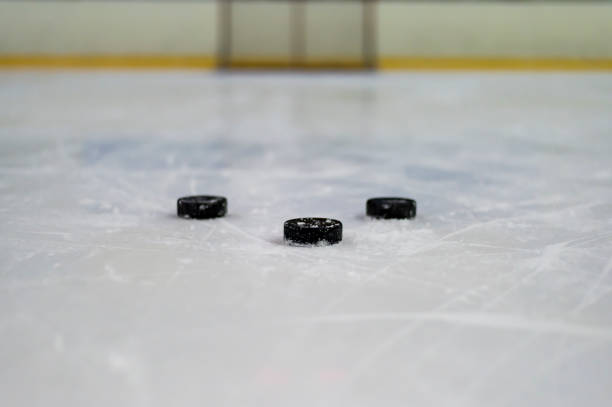 istock Hockey puck on ice 671945588