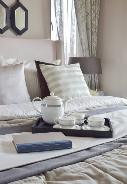 istock Decorative tray with book and tea set on the bed in modern bedroom 671955424