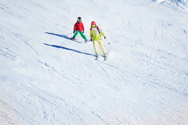 istock Two skiers hitting the slopes at snowy mountains 671958598