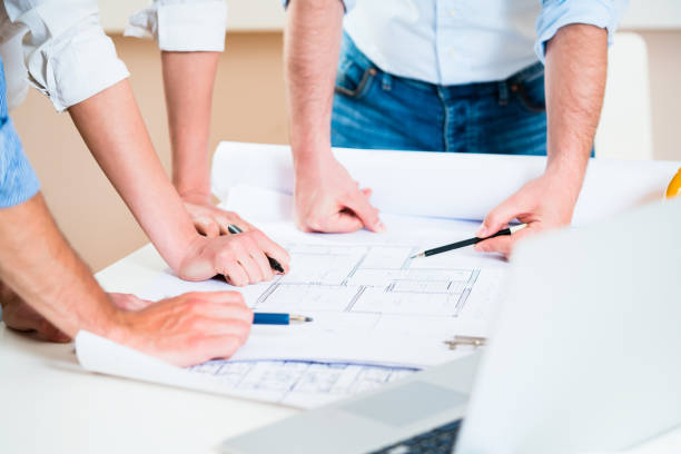 istock Discussion of construction plans in architects office 671961362