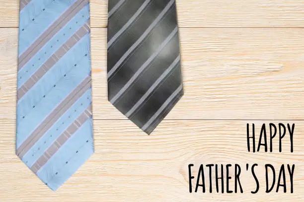 happy father's day, text and two neck ties over wooden planks