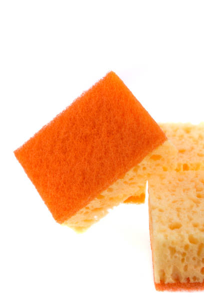istock A yellow and orange kitchen sponge isolated on white background. 671965140