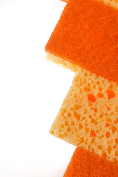 istock A yellow and orange kitchen sponge isolated on white background. 671965154