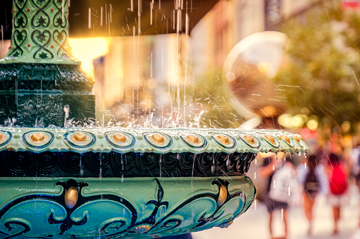 City fountain with water droplets in the business square district. Copy space