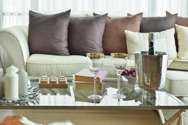 istock Wine glasses and wine bottle on table with beige sofa with dark brown pillows in modern classic living room 671974396