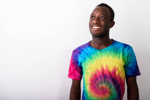 istock Studio shot of young black African man smiling and looking up while thinking against white background 671974620