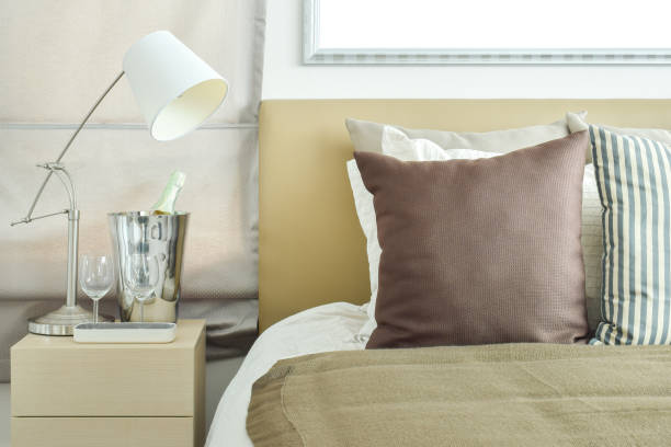 istock Light brown color scheme bedding with light brown headboard and table lamp 671974842