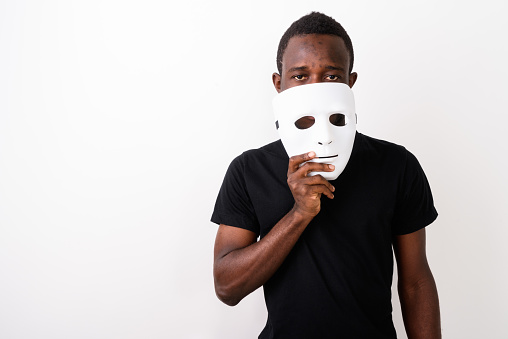 Person with a white mask is covering its ears with outstretched hands.