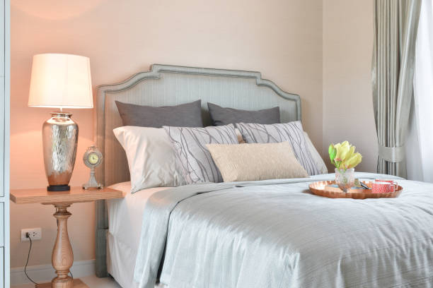 istock Decorative brass tray with glasses, book and sun glasses on bed 671984802
