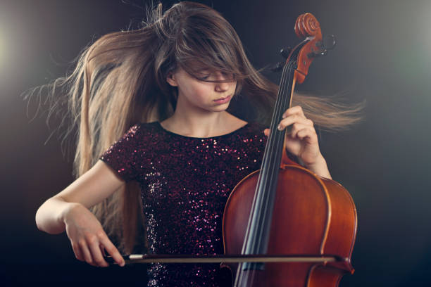 istock Teenage girl playing cello performance 671985136