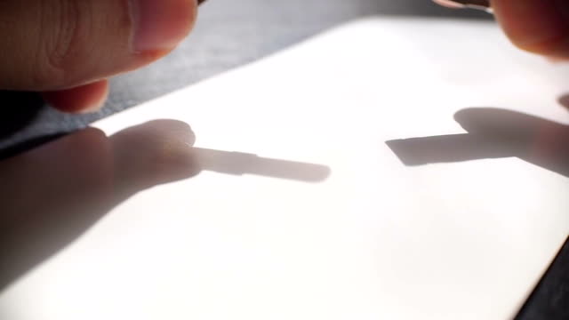 The artist inserts the pen in calligraph. Close-up video