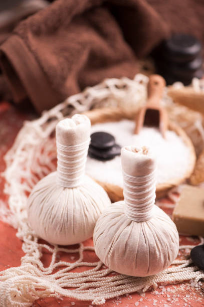 istock Spa massage with towel and herbal balls 671988294