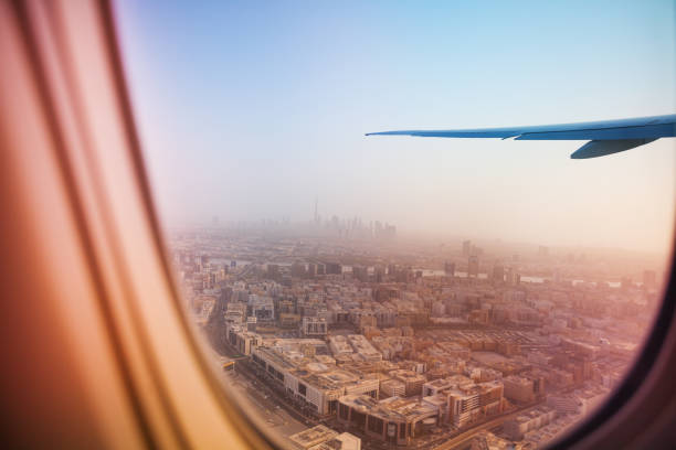 istock Evening cityscape of Dubai through aircraft window 671989330