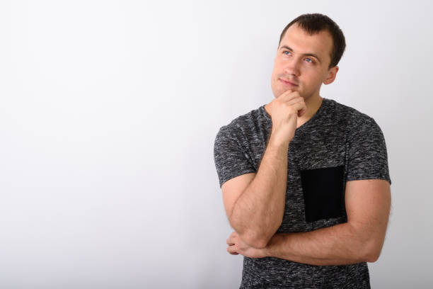 istock Studio shot of young muscular man thinking and looking up against white background 671991580