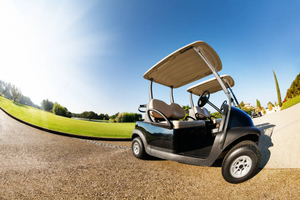 istock Car park with two golf-carts at sunny day 671992350