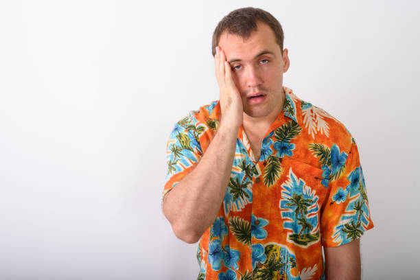 istock Studio shot of young muscular tourist man looking stressed while having headache against white background 671995604