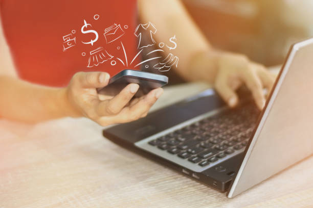 istock A woman's hand working on a laptop computer and interactive technology online on a smartphone. 671996076