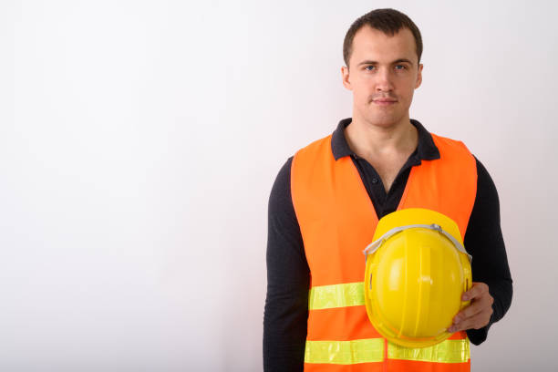 istock Studio shot of young muscular man construction worker holding hard hat against white background 672001854