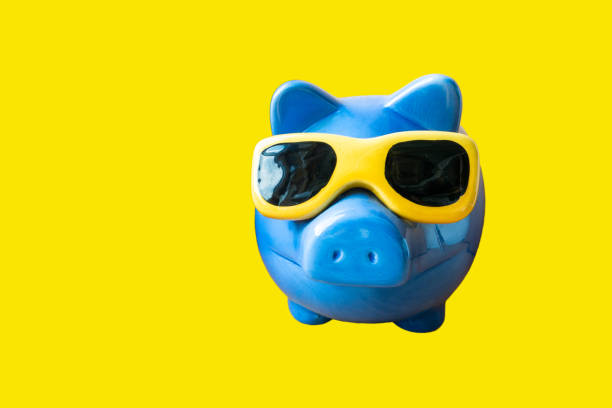 istock blue piggy bank with glasses on a yellow background 672002148