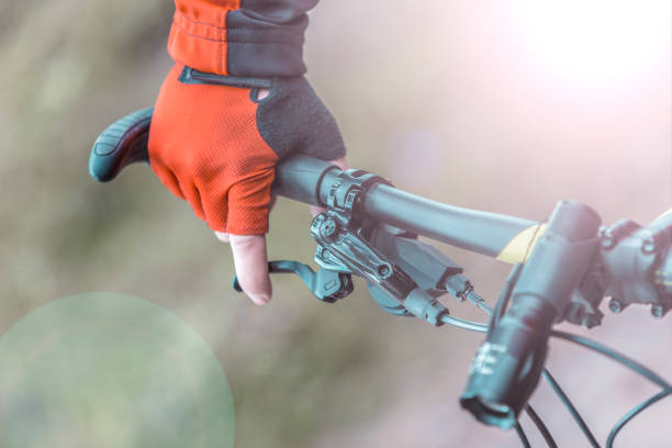 istock Biker Holds Breaks on Bike Helm 672002988