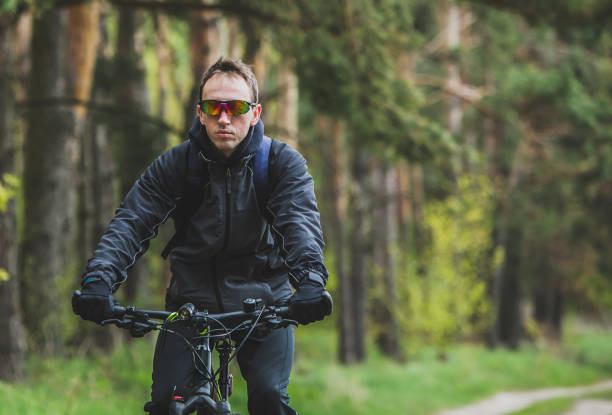 istock Man Rides a Bike in the Forest 672008284