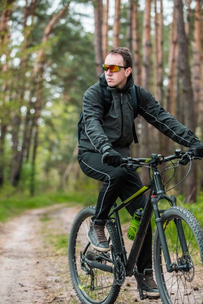 istock Man Rides a Bike in the Forest 672008436